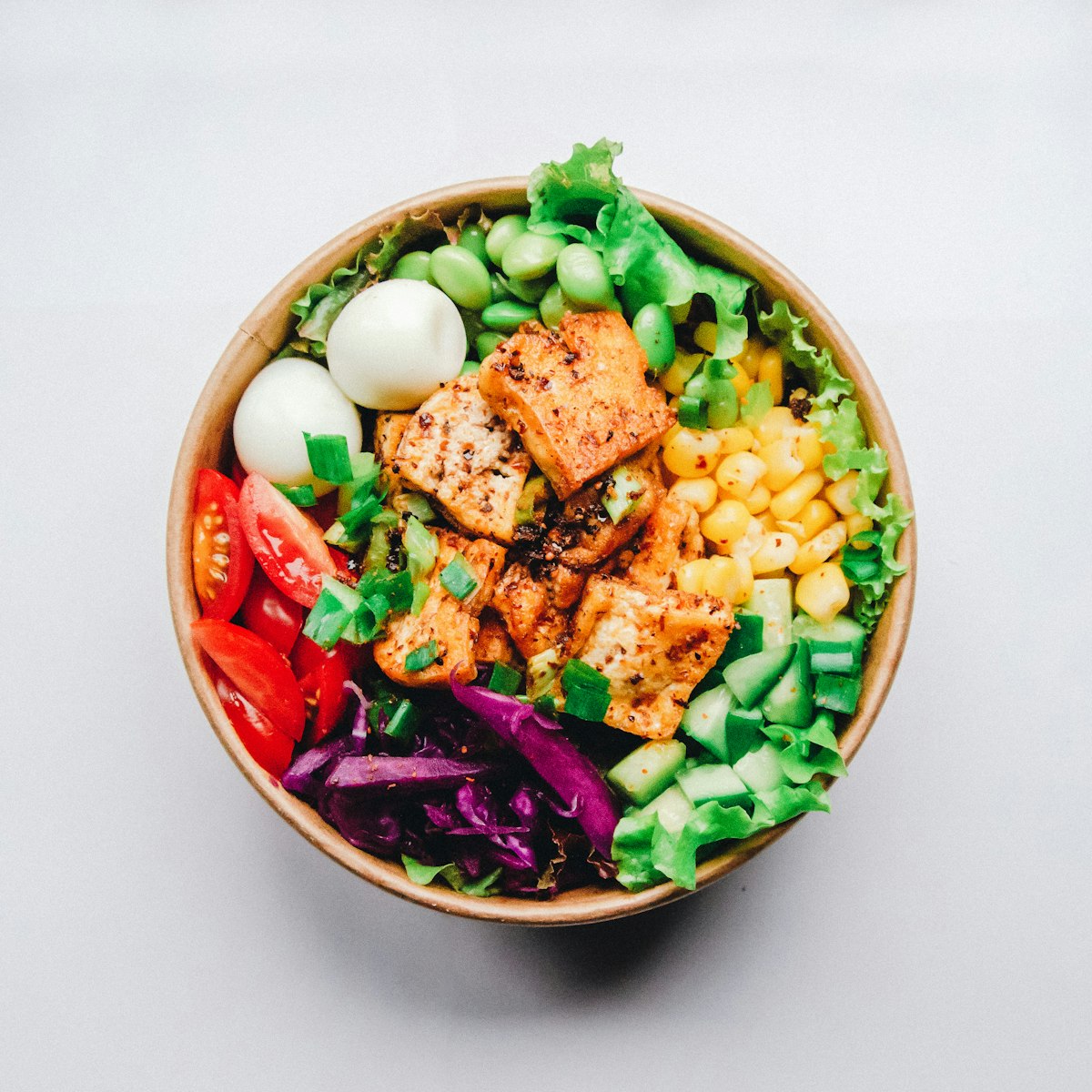 Fresh vibrant salad bowl with greens, avocado, and cherry tomatoes